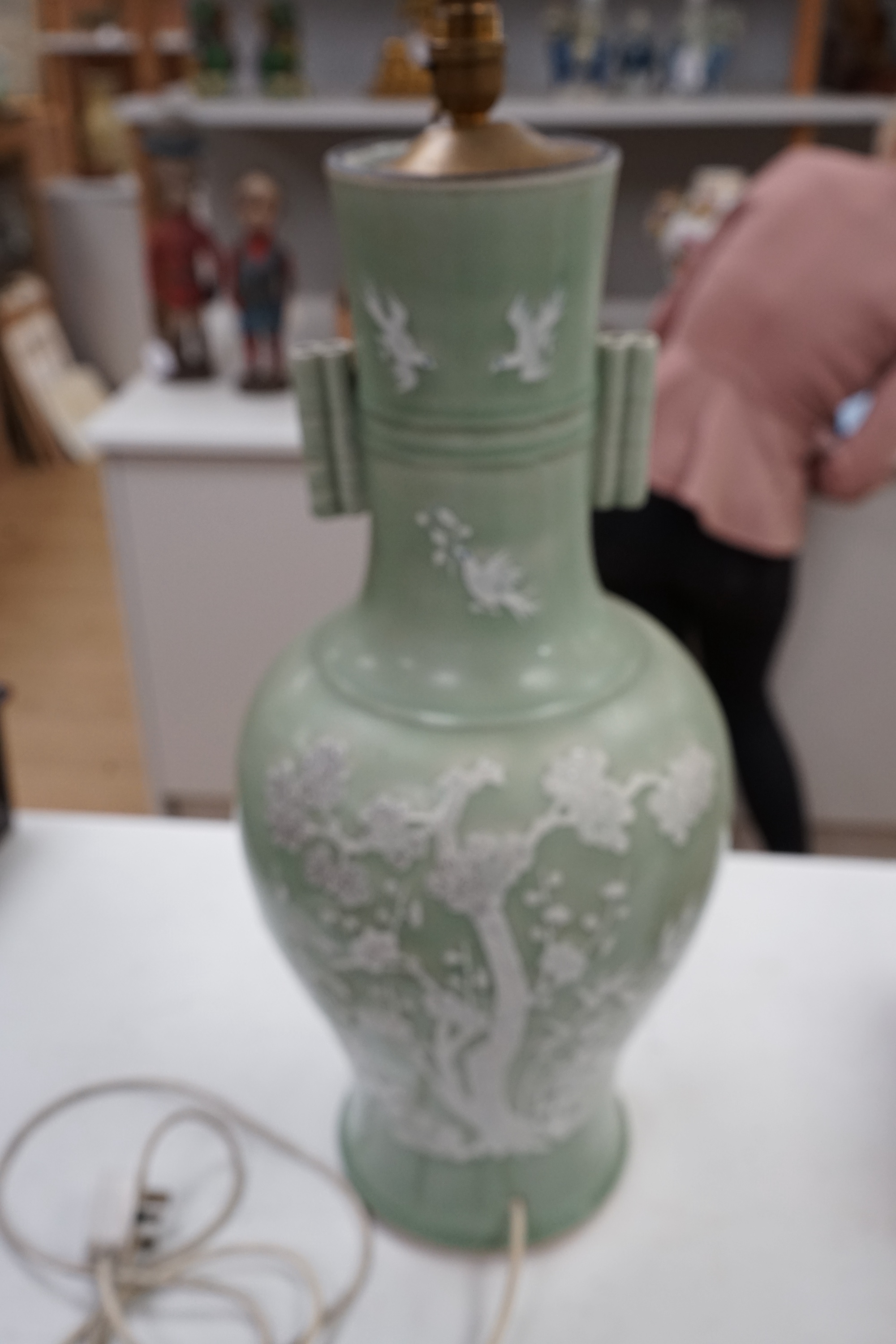 A large Chinese underglaze blue and slip decorated celadon ground vase, converted to a lamp, 61cm high. Condition - a crack 16cm down the side of the body